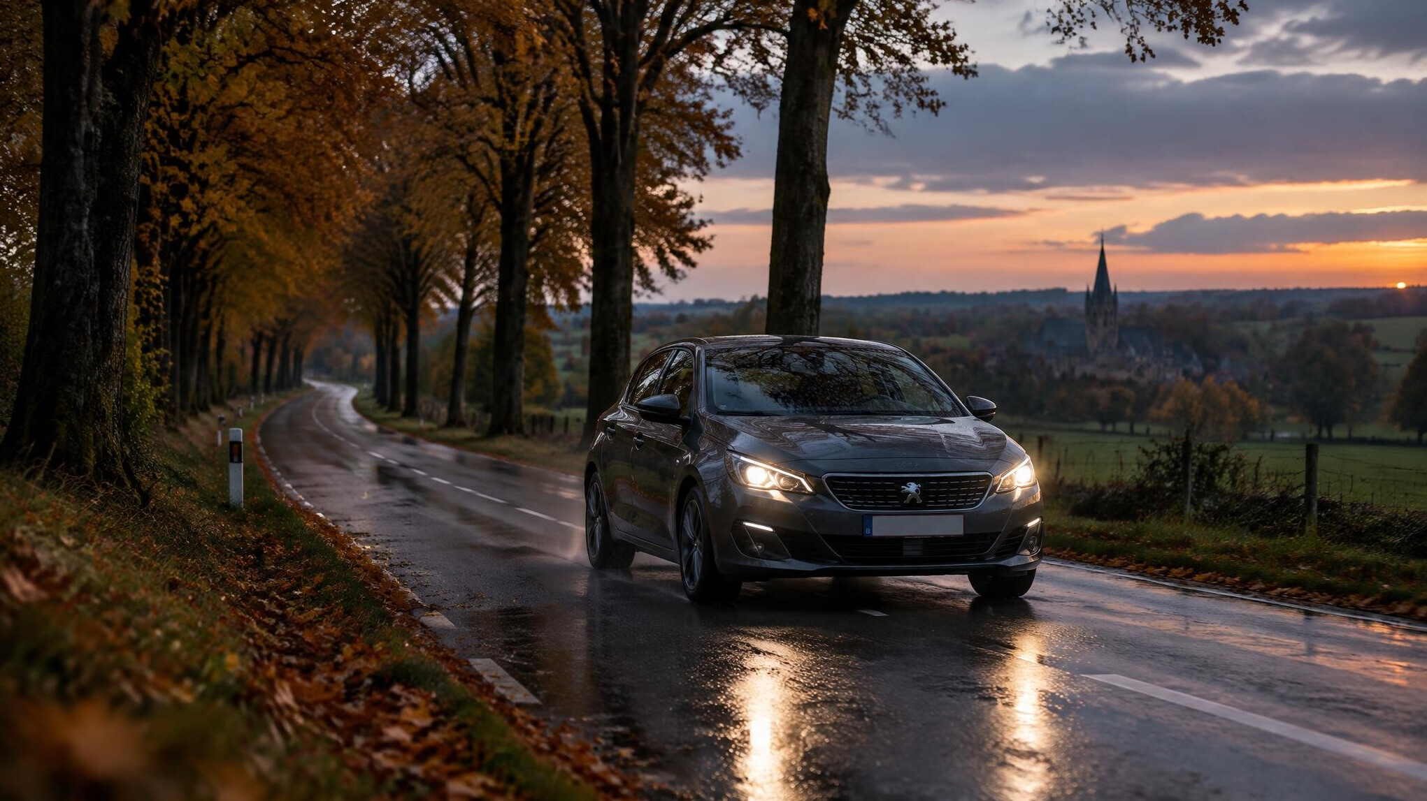 Car driving on a wet road in autumn